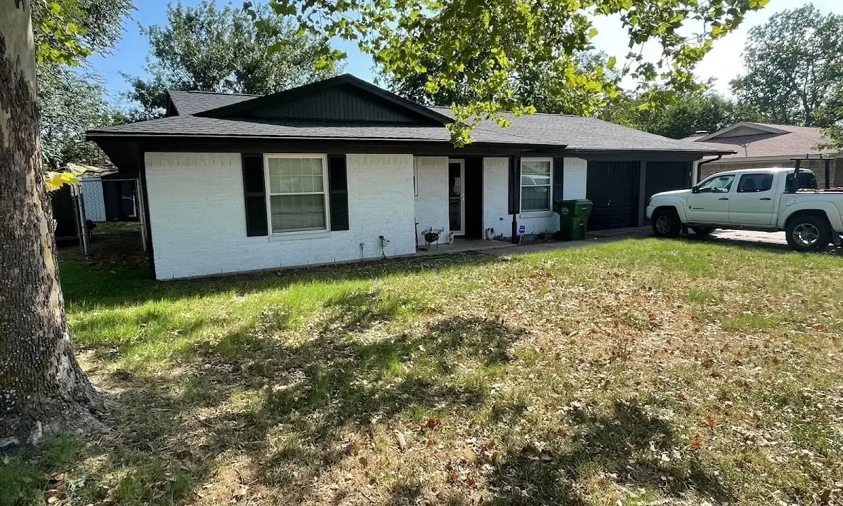 Professional roofing crew working on a residential roof in Gardere